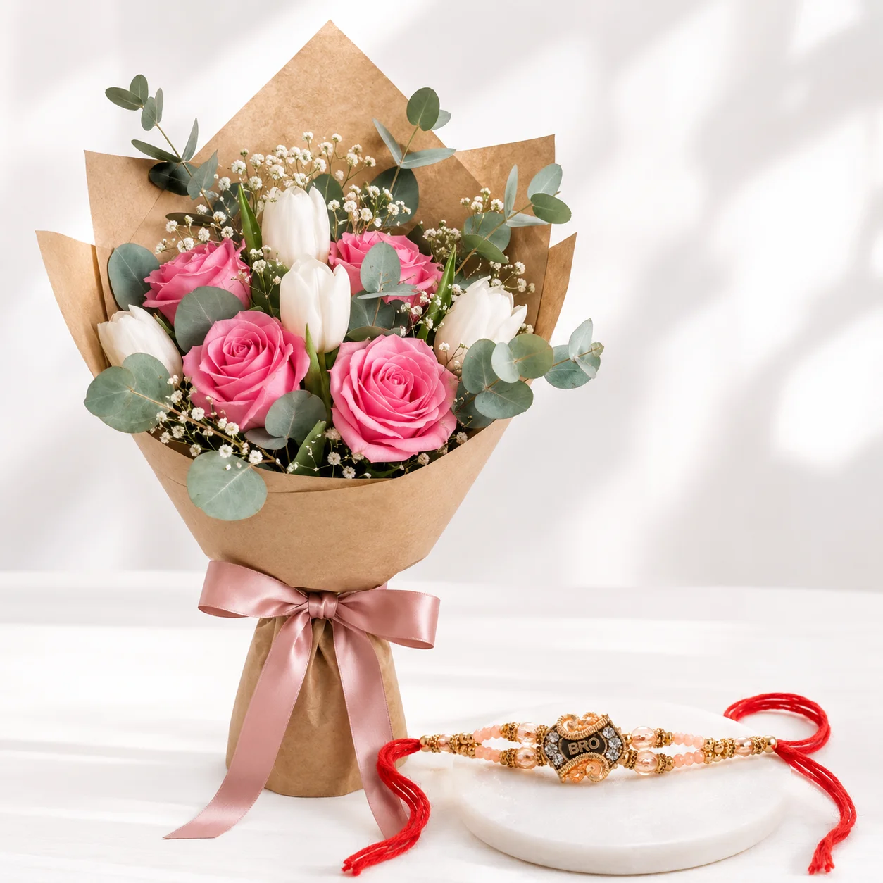 Rose and Tulip Rakhi Bouquet featuring four pink roses five white tulips and a stylish Bro rakhi for Raksha Bandhan gifting